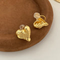 Minimalist silver heart-shaped stud earrings for women on copper base