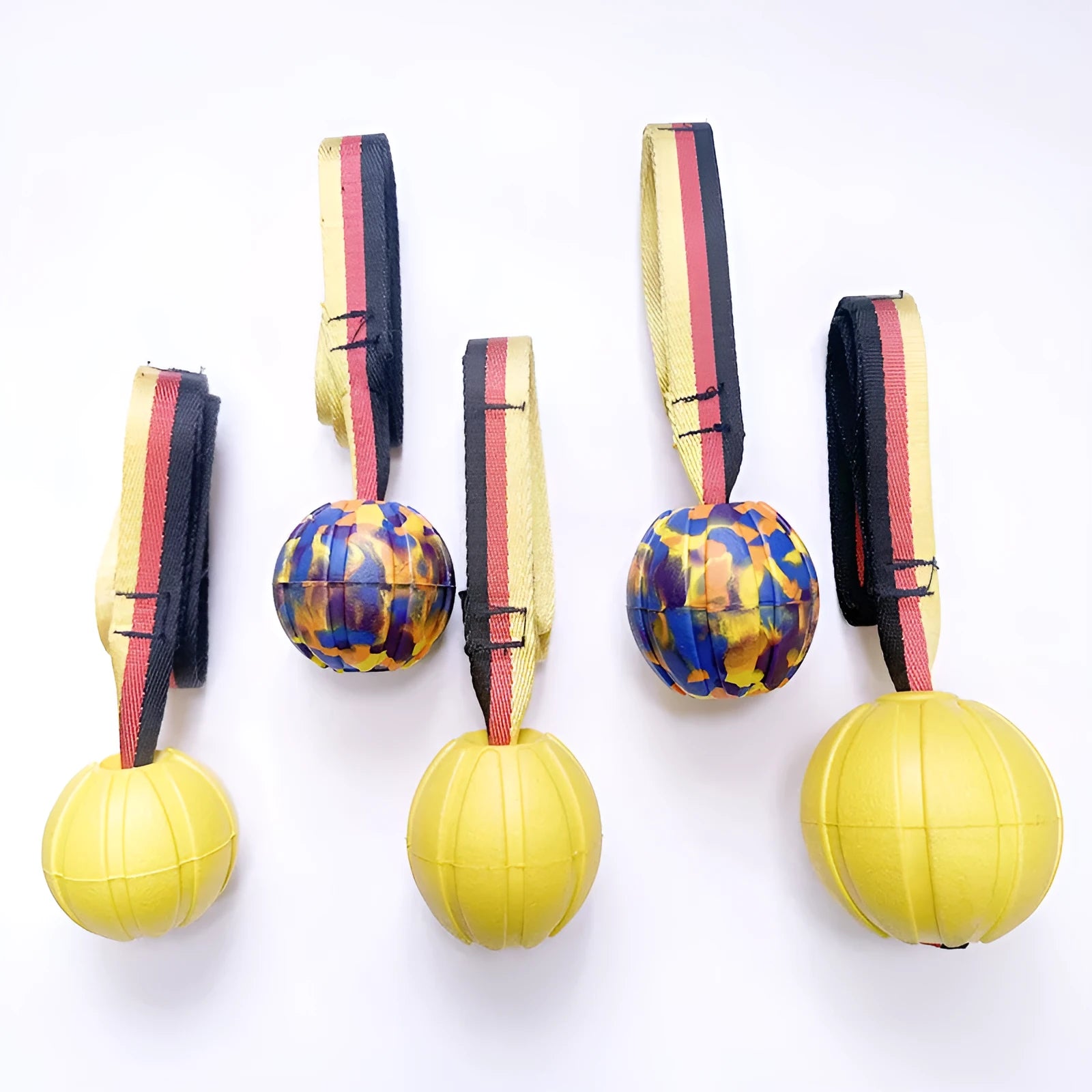 Floating EVA dog training ball with attached string in camouflage and yellow colours, showing three diameter sizes