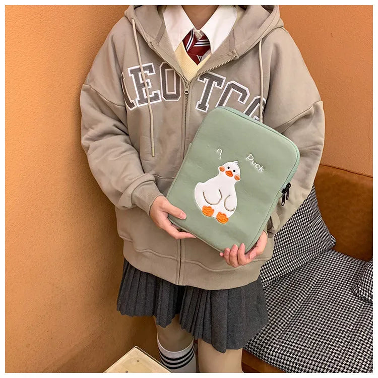 Blue cotton tablet case with an embroidered cartoon duck design and a silver zip closure.