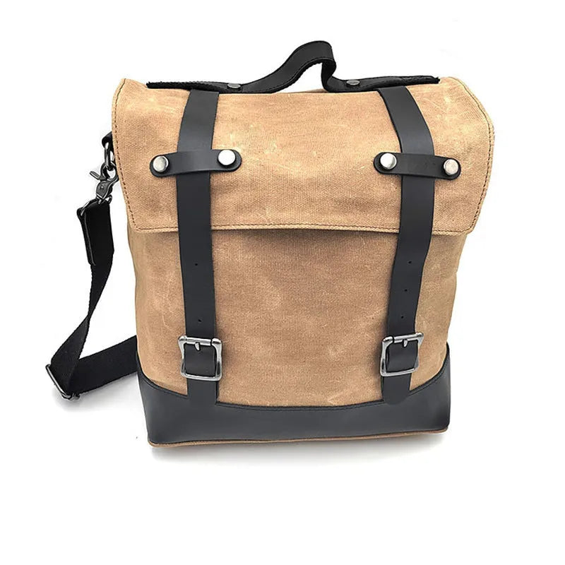 Black waterproof canvas motorcycle side bag with cowhide trim mounted on a bike