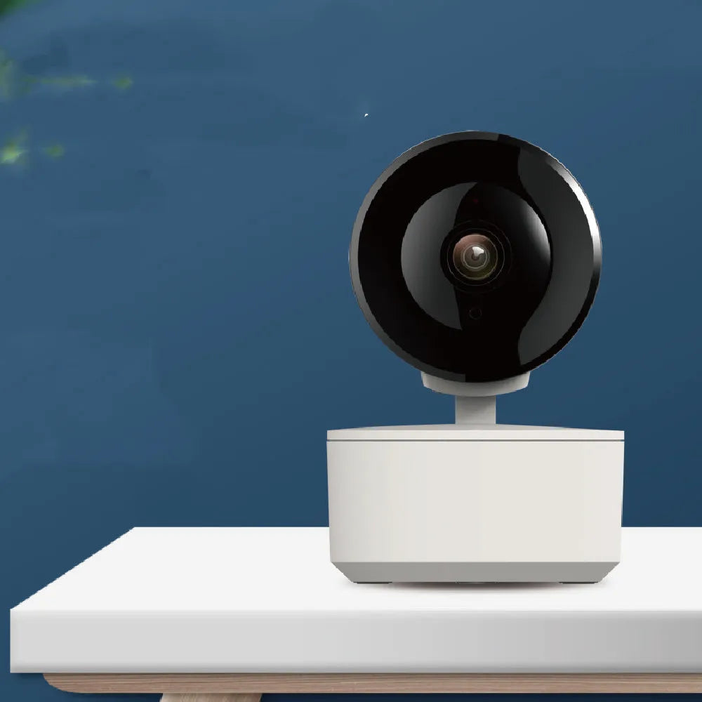 White indoor dome security camera with pan-tilt base on a desktop, showing 355-degree rotation range.