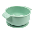 Blue silicone pet bowl for dogs and cats with a non-slip suction cup base on a hardwood floor.