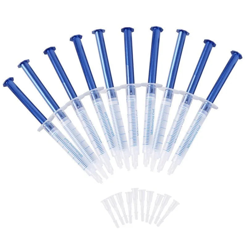 Bright Teeth Whitening Kit with LED cold light device and desensitizing gel syringes on a white background