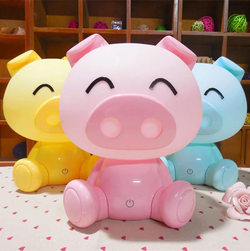 Cartoon pig small night lamp in blue showing soft LED glow, ABS body with USB power connection