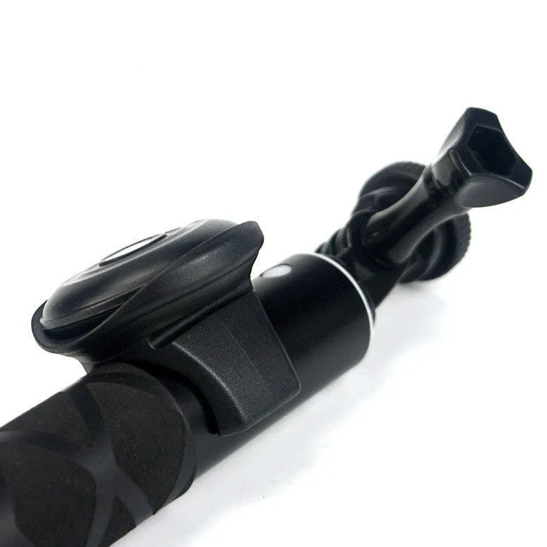 Black Snap Bluetooth remote control for smartphone photos on a white background.