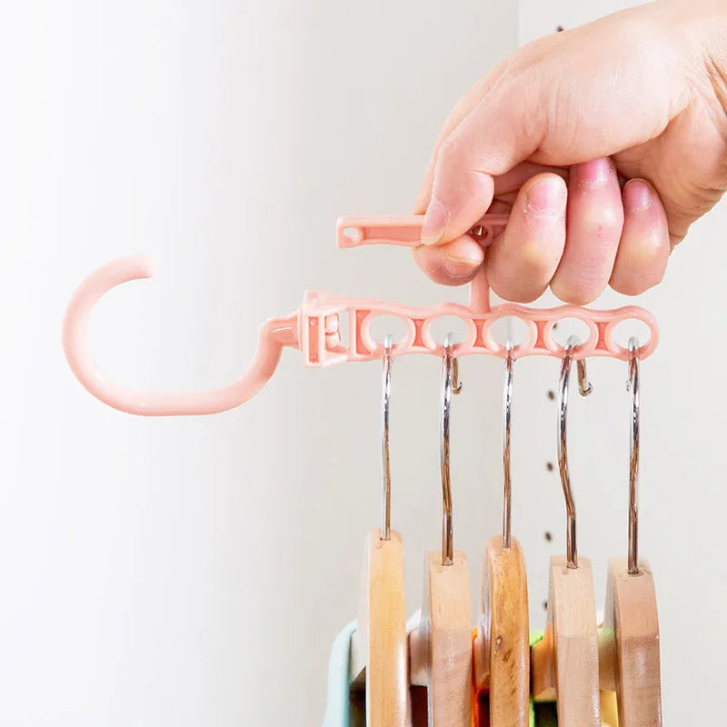 Blue revolving wardrobe hanger with five arms and a central handle for space-saving clothes storage.