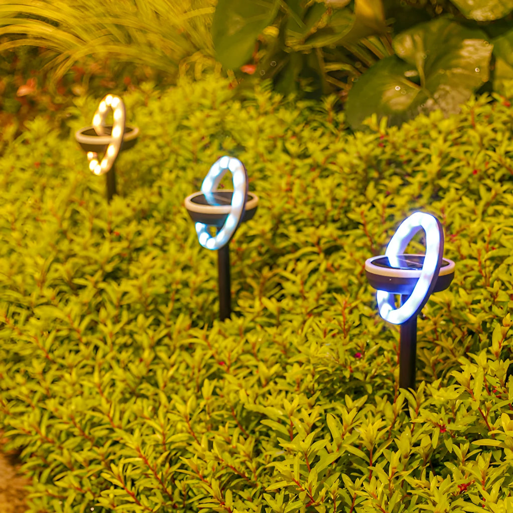 12LED rotating solar lawn light with IP65 rating in a garden setting, white light option, 103x103x340mm spike