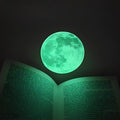 30cm green fluorescent glow moon wall sticker on a wall, glowing in the dark