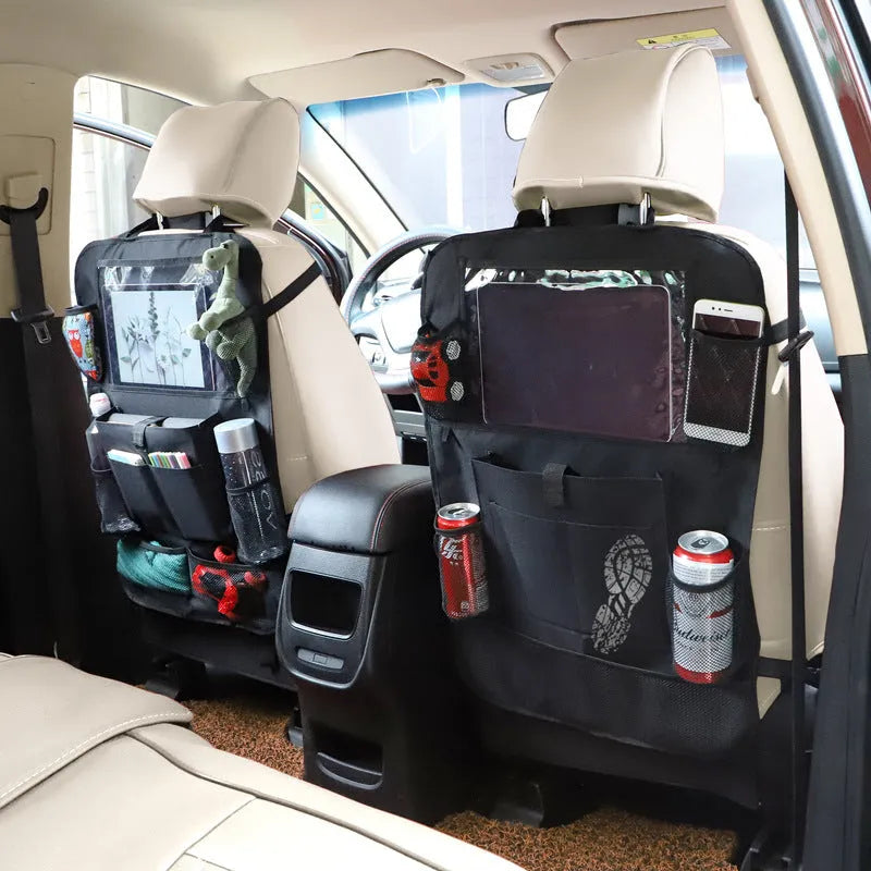 Black multi-pocket car organiser hanging on back seat headrest with phone and drink holders