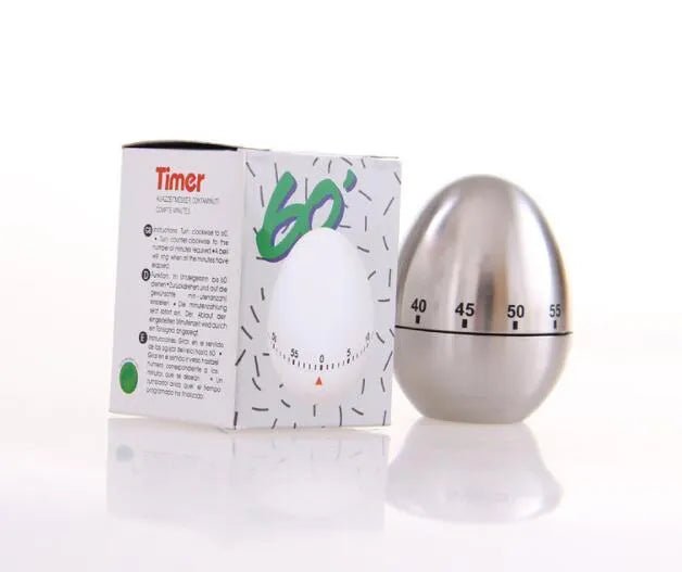 Stainless steel egg-shaped mechanical kitchen timer on countertop