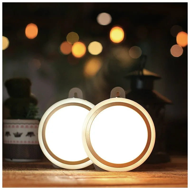 Circular white motion sensor LED light with a compact design, shown mounted on a wall.