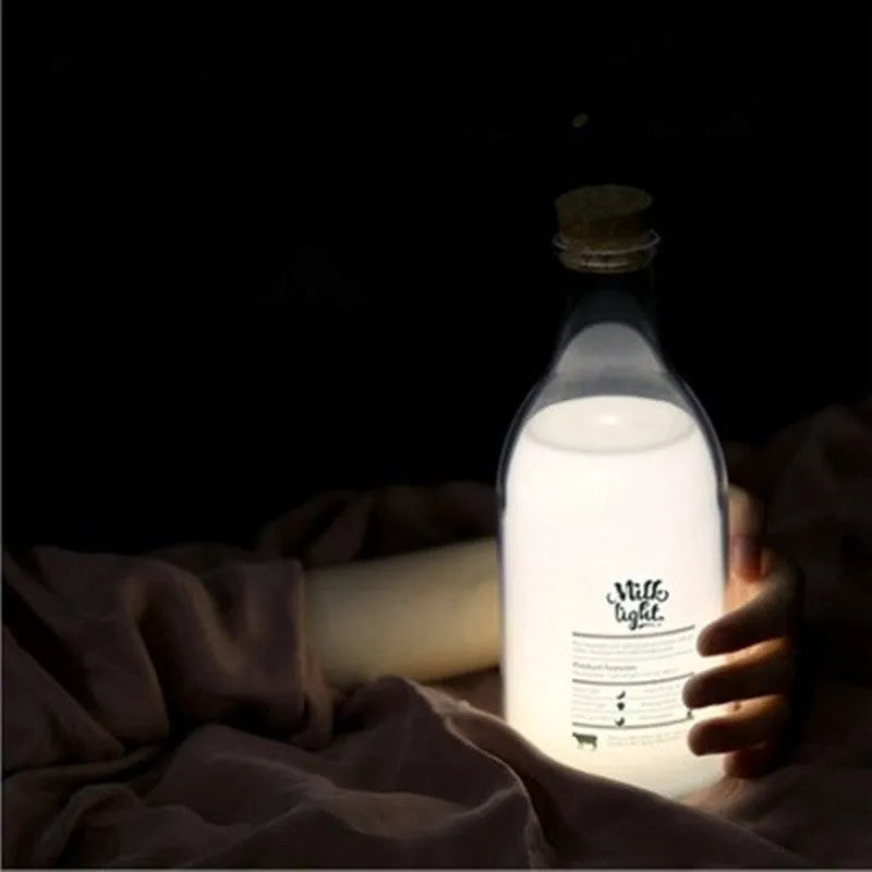 White milk bottle shaped LED nightlight on a wooden surface, USB rechargeable, with a 30-minute timer and DIY message panel