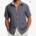 Men's floral print short-sleeved shirt in light grey polyester fabric on a hanger.