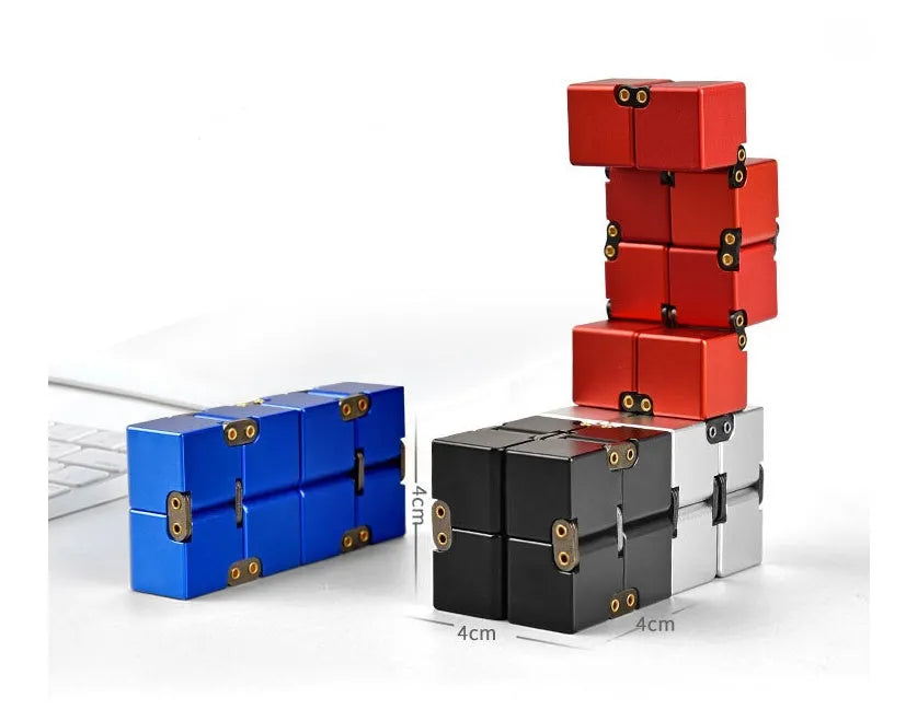Zinc alloy infinity cube fidget toy showing black and silver rotating cube puzzle on a desk.