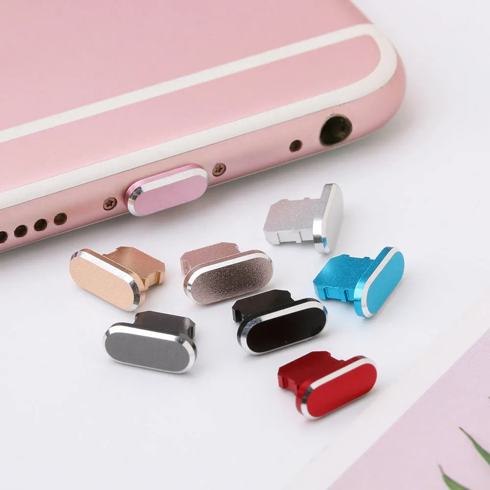 Aluminium alloy iPhone charging port dust plug in various colours on a dark background