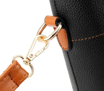 Women's PU leather crossbody shoulder bag in Black with silver-tone clasp, worn over shoulder