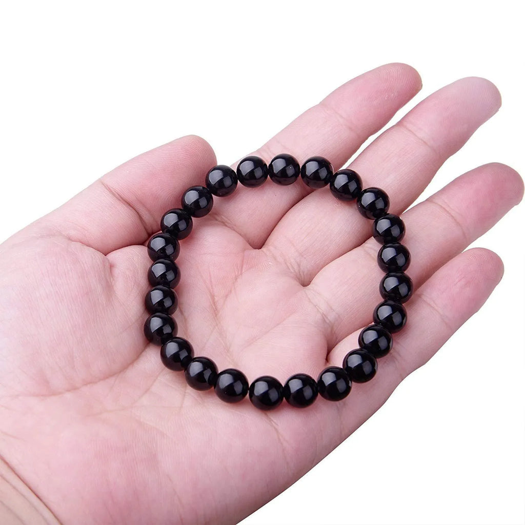 Women's geometric black agate bracelet with elastic cord, shown in 8mm bead size.
