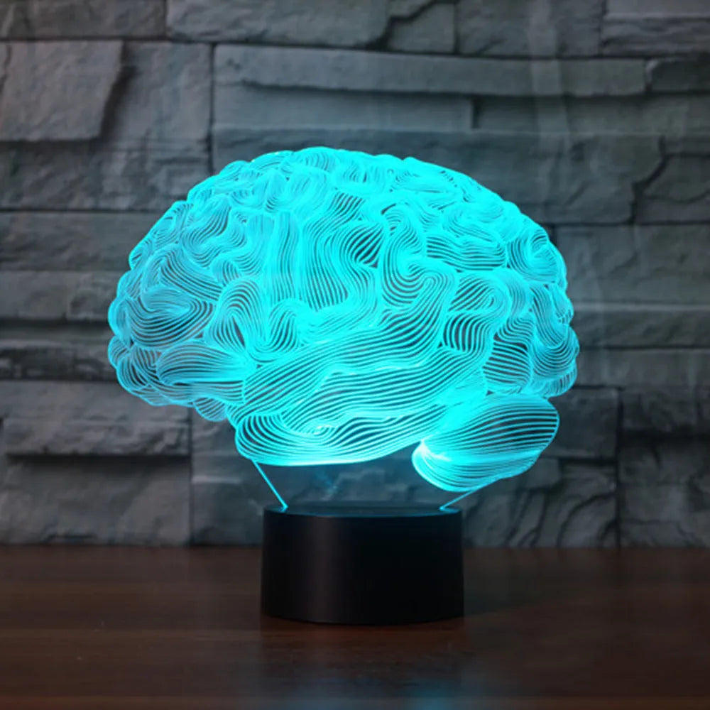 3D acrylic illusion desk lamp with colourful LED lights on a wooden desk, remote control nearby.