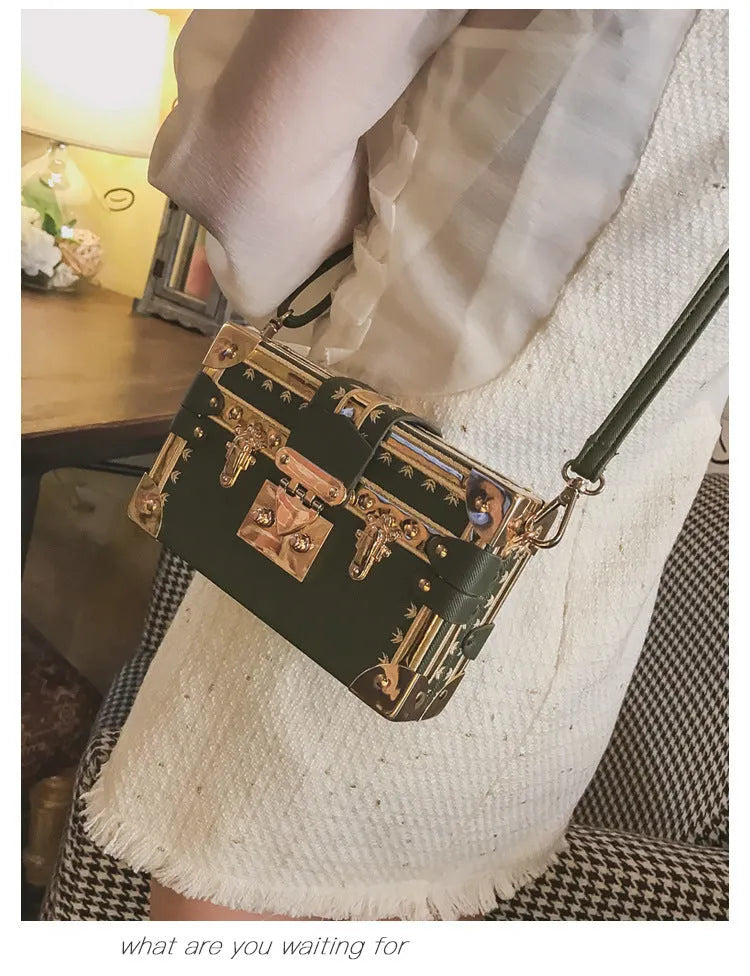 Structured hard PU women's shoulder bag with a flap, hasp closure, and adjustable strap.