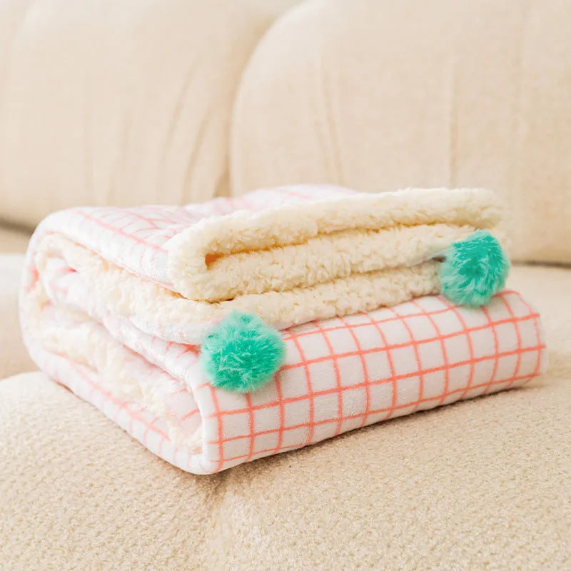 Thickened coral fleece dog blanket in blue, size 70x50cm, on a wooden floor