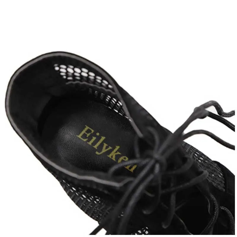 Black suede women's lace-up high heel shoes with a pointed toe and stiletto heel.