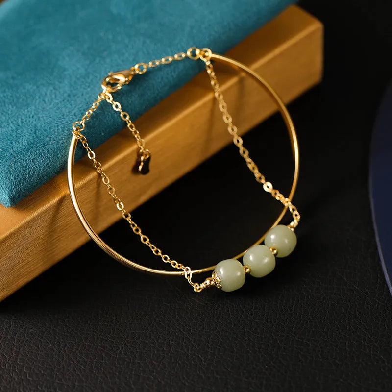 Women's Hetian jade bracelet with gold inlay design in single, double, or three-bead versions.