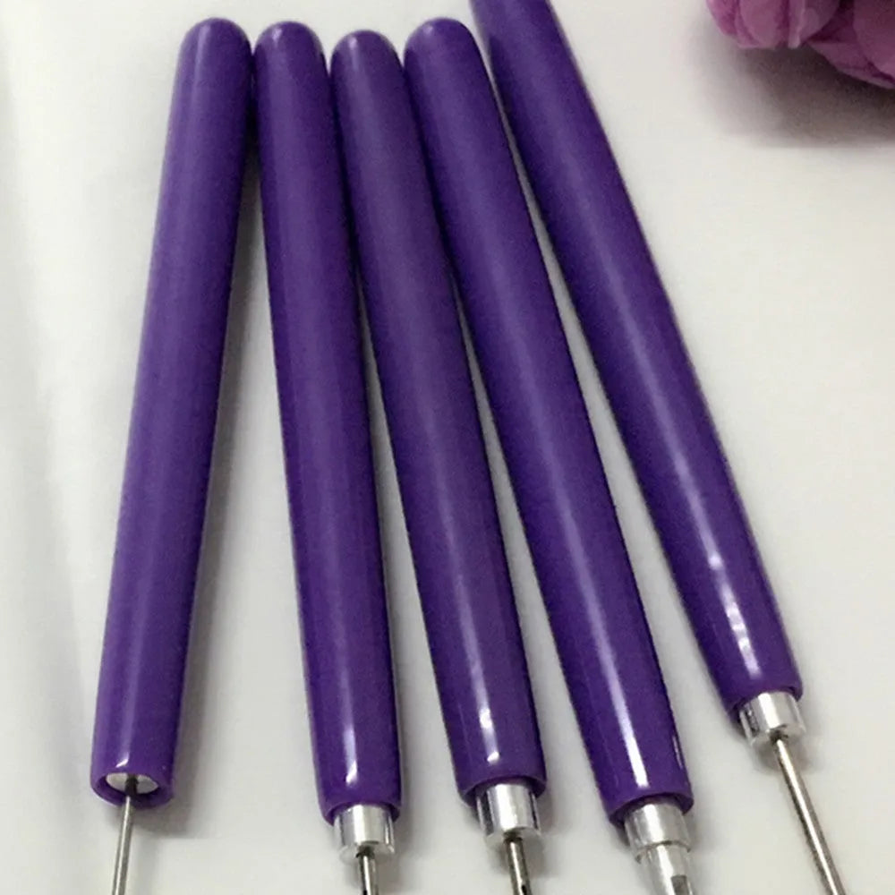 Purple quilling paper tool set with five slotted pens and needle stylus on white background