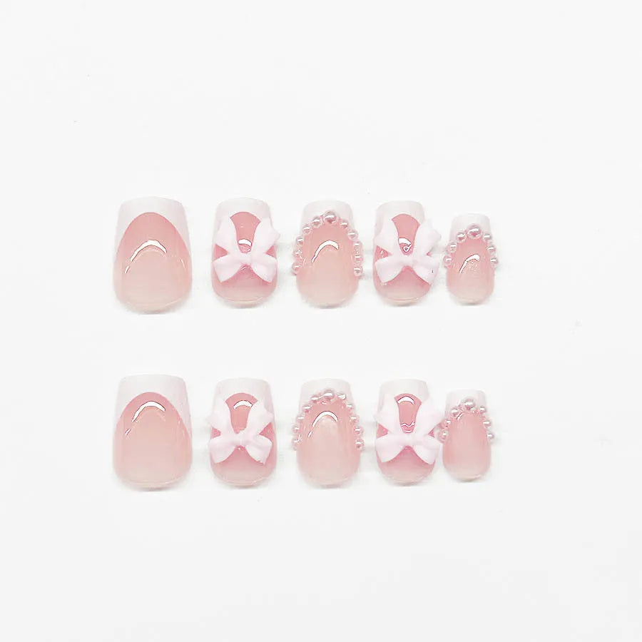 Set of 24 short French manicure false nails with white tips, bow designs, tulip patterns, and leopard print on a European square shape.