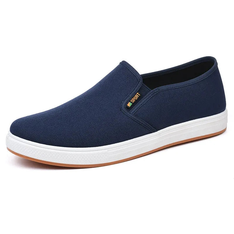 Men's low-top canvas slip-on shoes with rounded toe and injection moulded soles in black and blue colour options