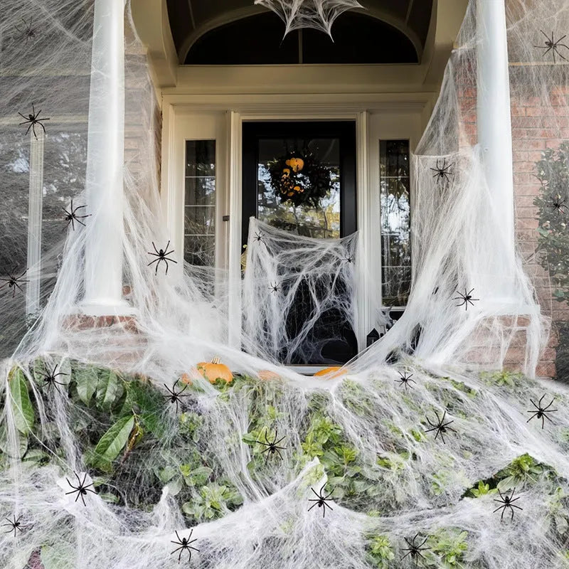 White cotton spider web Halloween decorations showing various weight packages with included plastic spiders