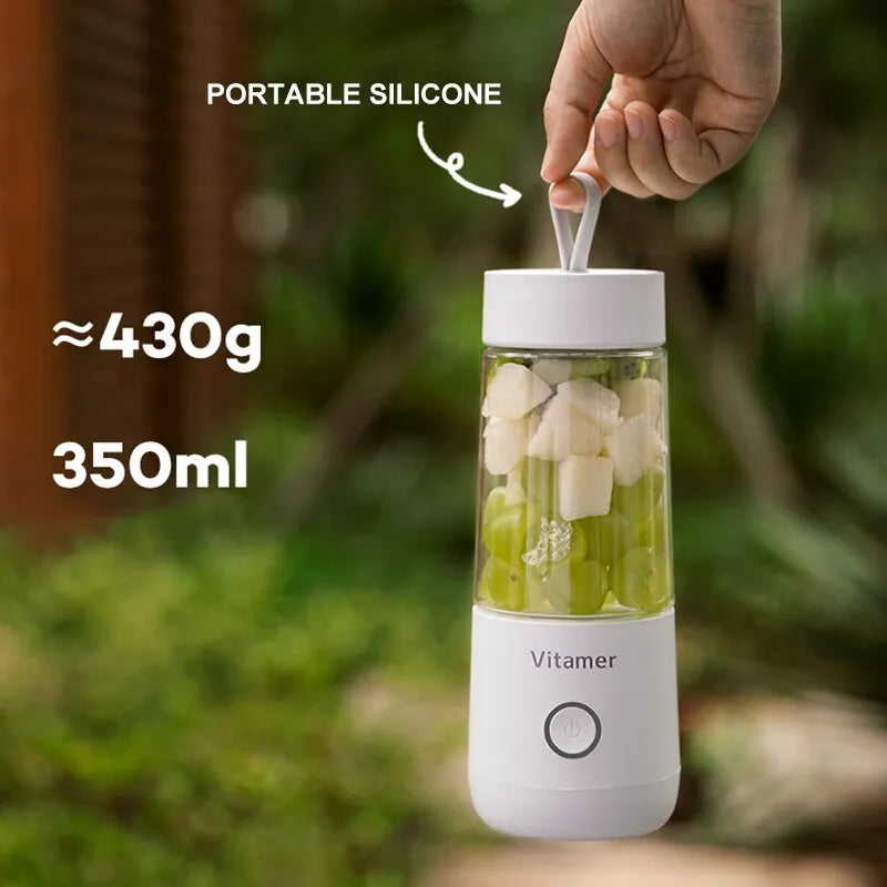 White portable USB blender with 350ml cup and silicone carry ring on a base.