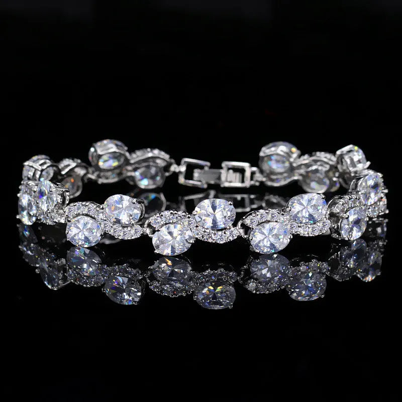 Geometric gold electroplated women's bracelet with inlaid AAA+ zircon stones on a copper base.