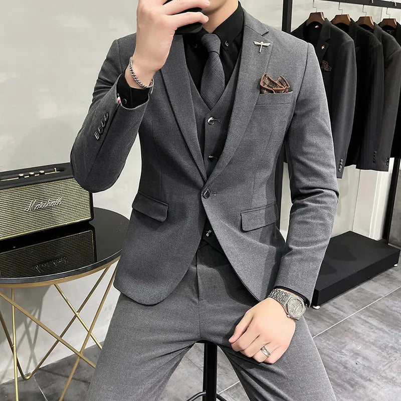 Three-piece men's acetate fibre blend business suit set in light gray with jacket, trousers, and vest.