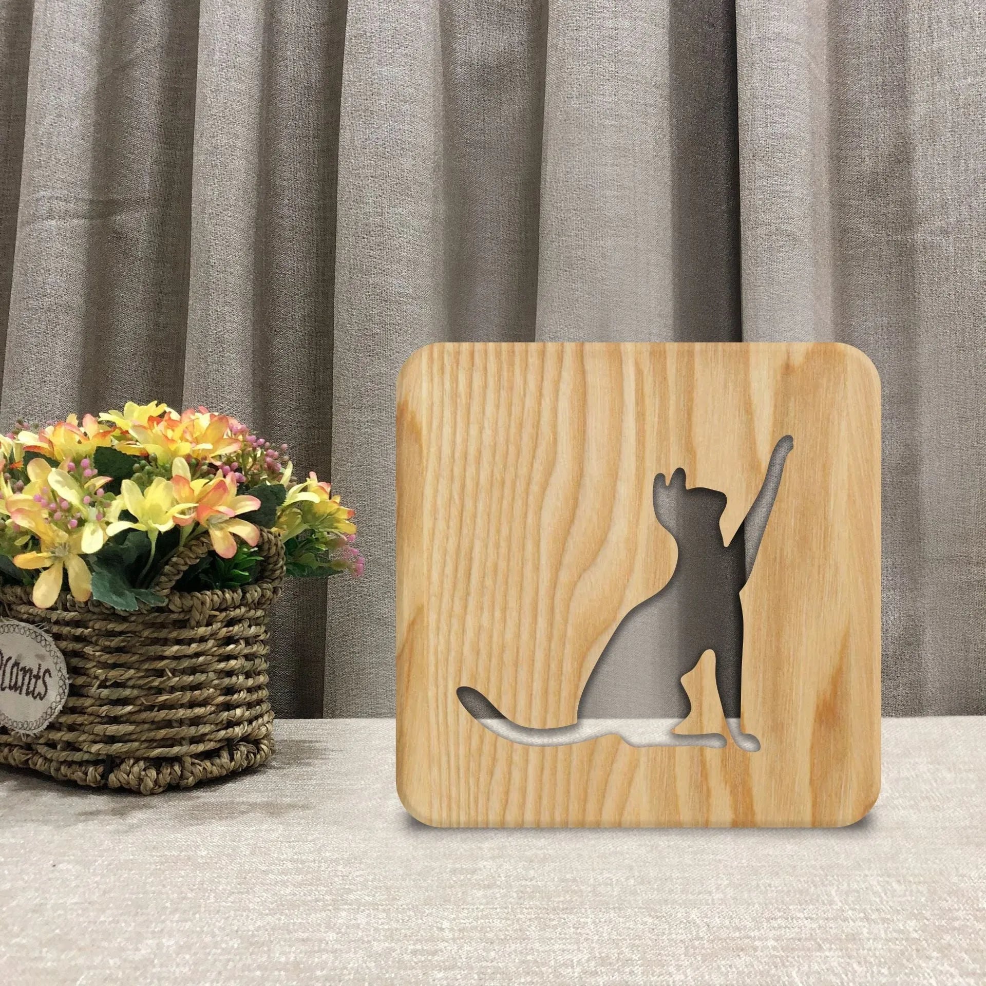 Solid wood cat-shaped 3D night light with hollow silhouette, lit with warm glow.