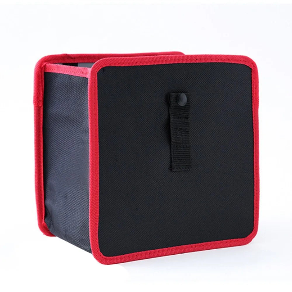 Foldable black Oxford car wastebasket with adjustable strap held on red seat headrest