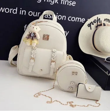 Women's black PU leather three-piece set showing backpack, shoulder bag, and card purse together.