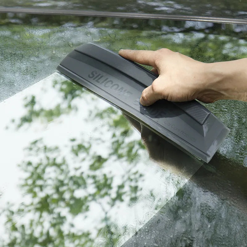 One-piece black silicone car wash wiper with flexible handle on car bonnet