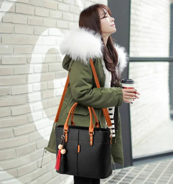 Women's PU leather crossbody shoulder bag in Black with silver-tone clasp, worn over shoulder