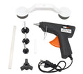 Plastic car body dent repair tool kit with glue gun, screw cap, holder, glue stick, and three traction strips on a white background