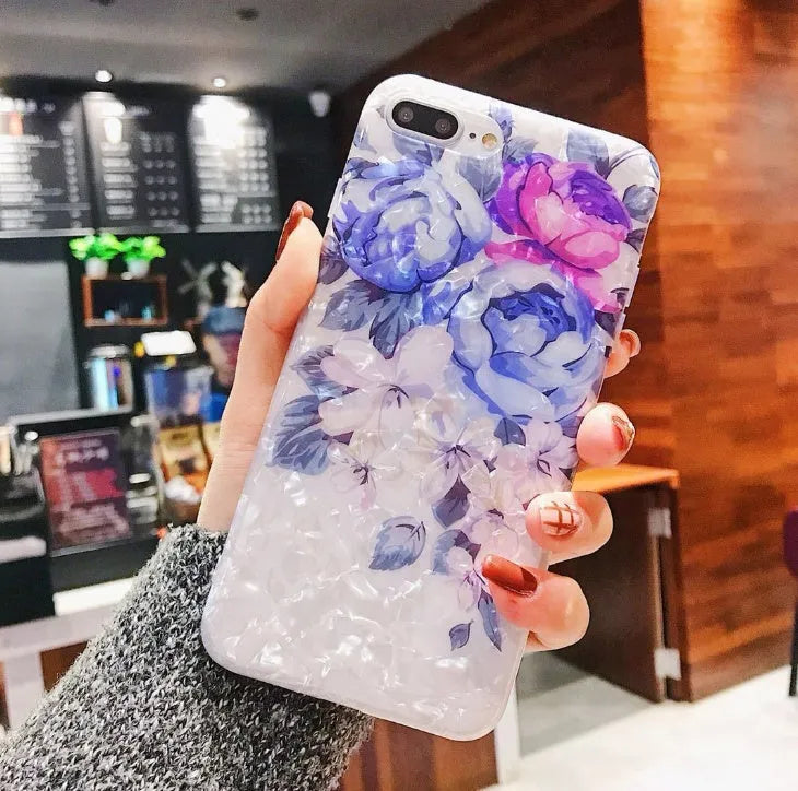 Soft TPU silicone iPhone case with a rose flower design on the back in brown, shown fitted to a phone.