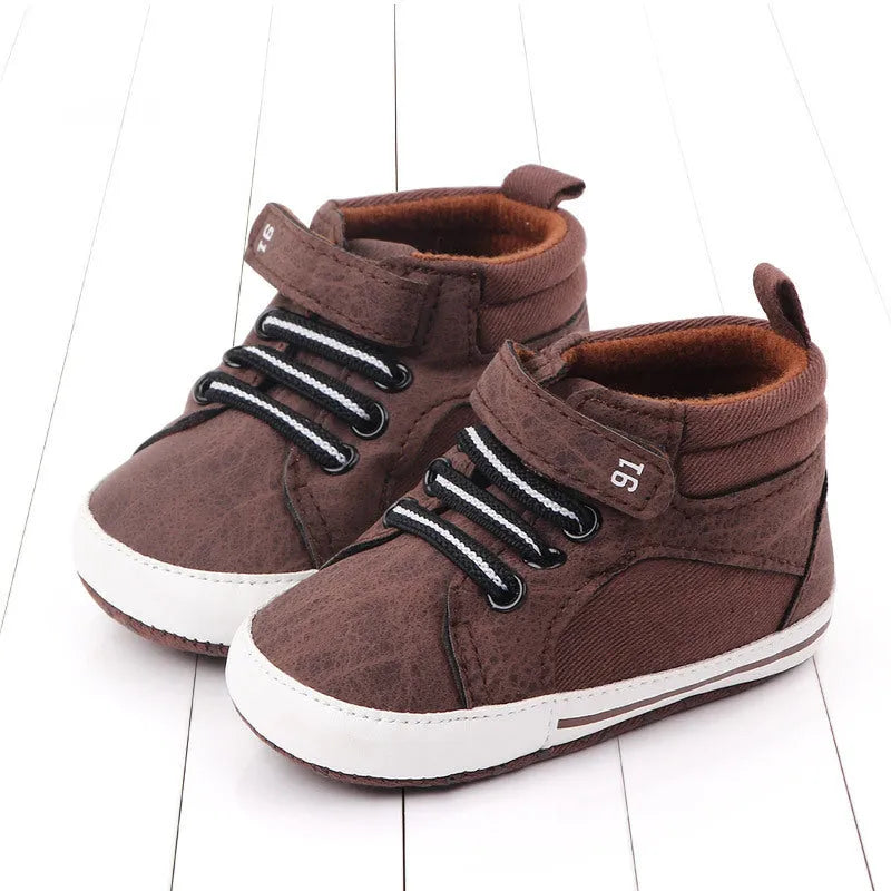 Blue cotton high-top toddler shoes with velcro strap for boys on white background