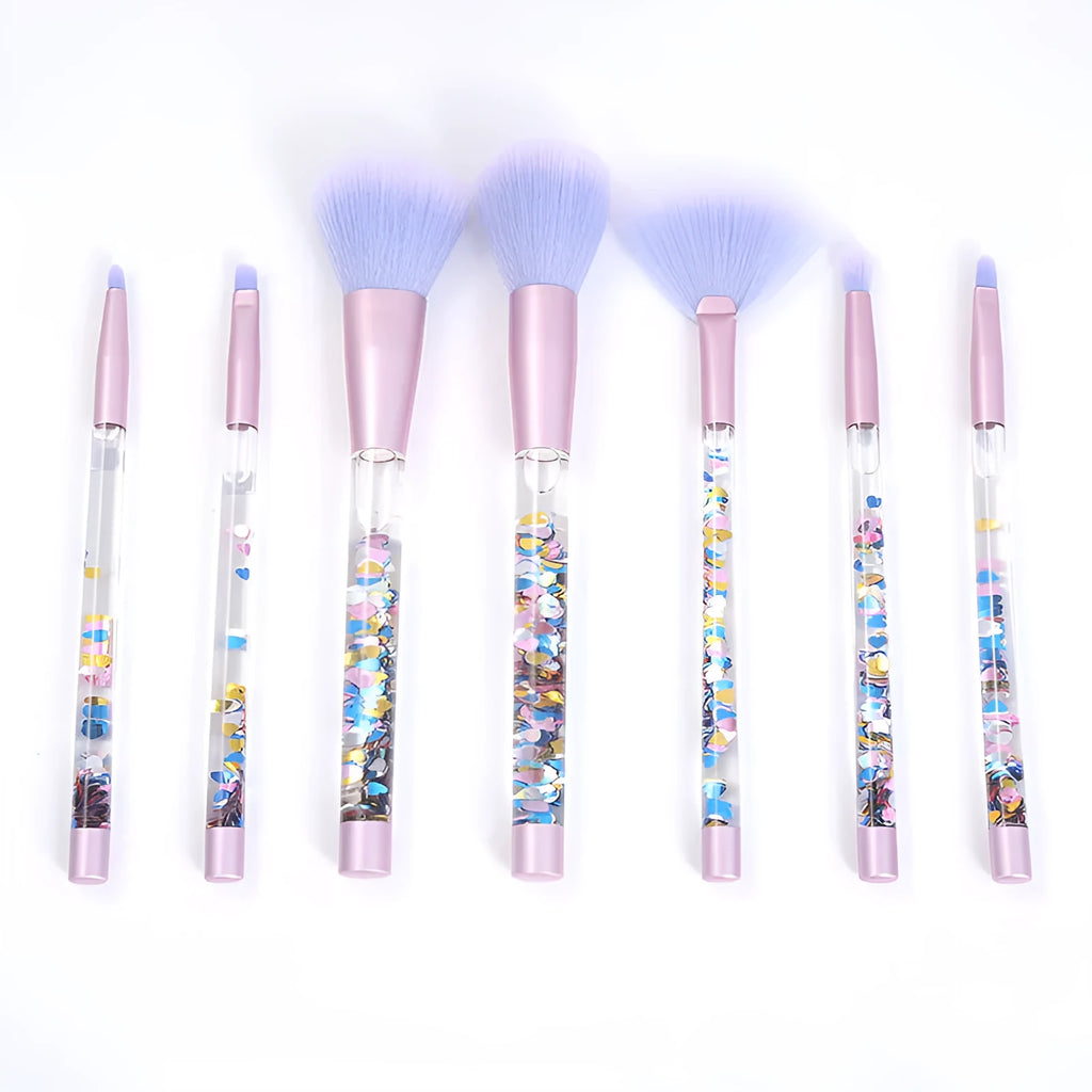 Set of 7 makeup brushes with pink handles, black bristles, and long plastic handles on a light background