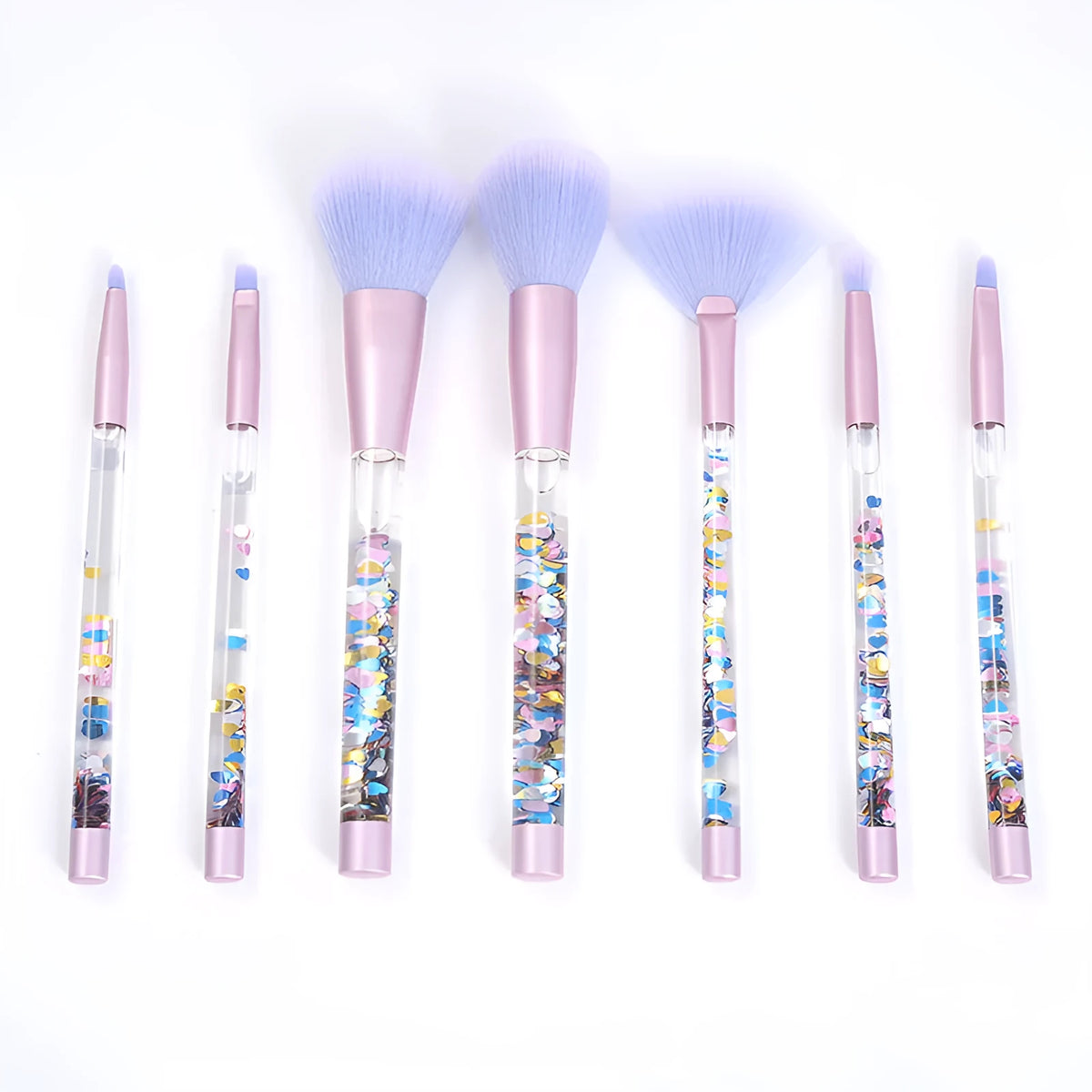 Set of 7 makeup brushes with pink handles, black bristles, and long plastic handles on a light background