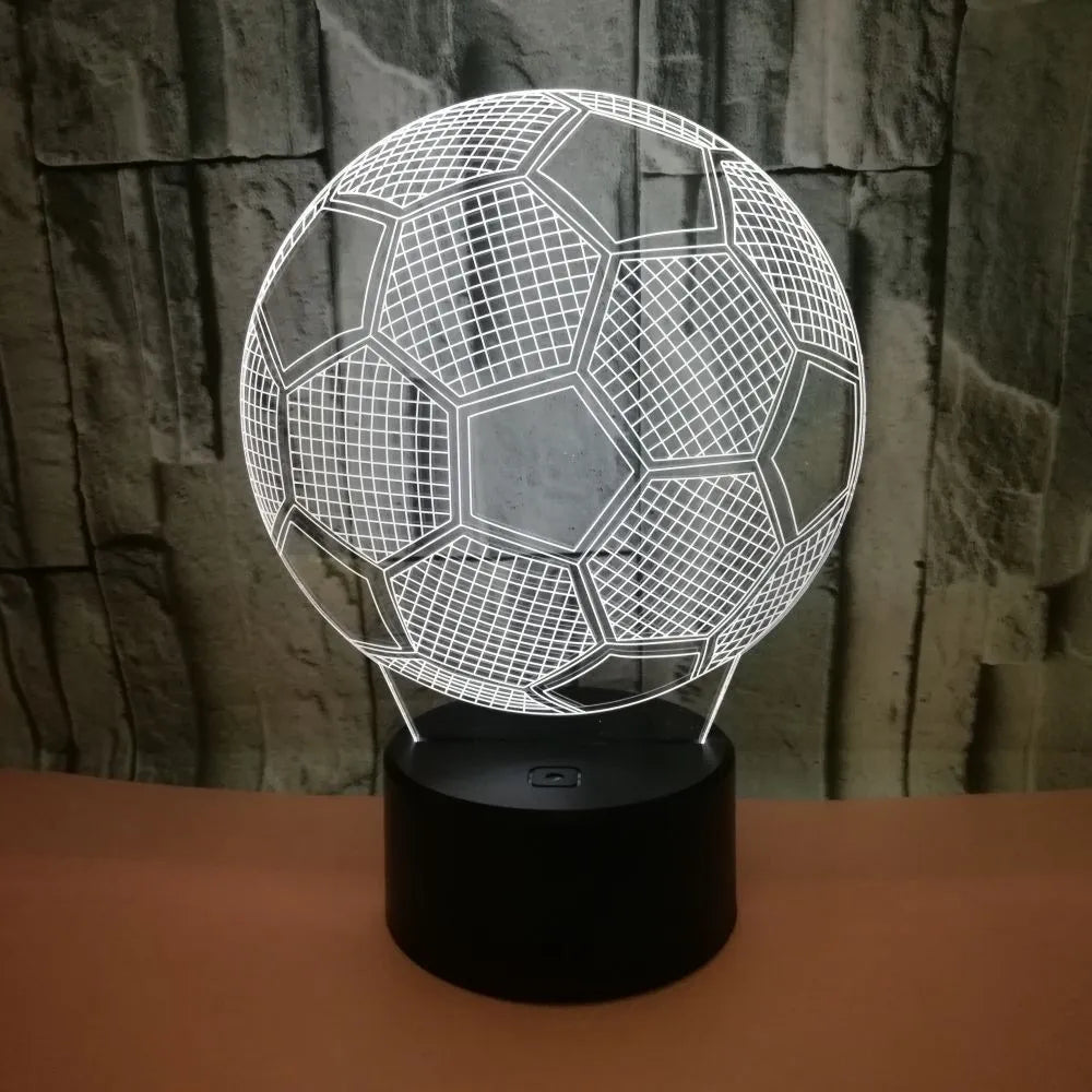 3D football-shaped LED night light on a black base showing multi-colour gradient illumination.