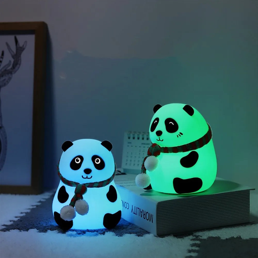Panda-shaped silicone night light with USB cable on a wooden surface