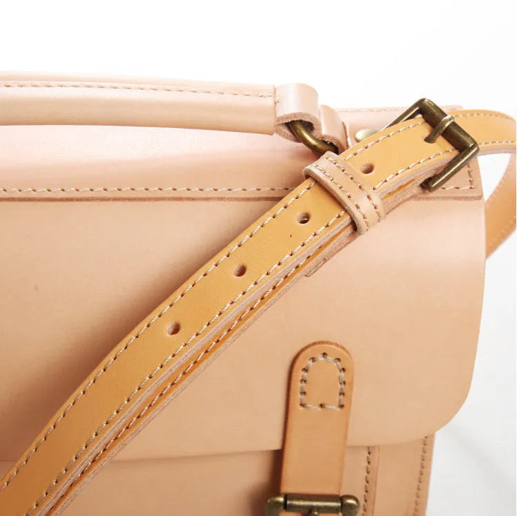 Hand made leather crossbeam bag in primary colour with full-grain cowhide exterior and leather lining, side view showing structured shape