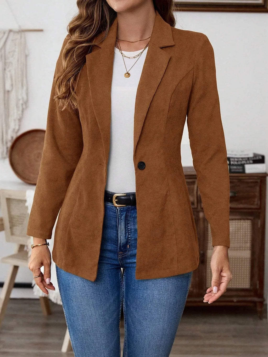 Brown men's single-breasted lapel coat with long sleeves on a hanger.
