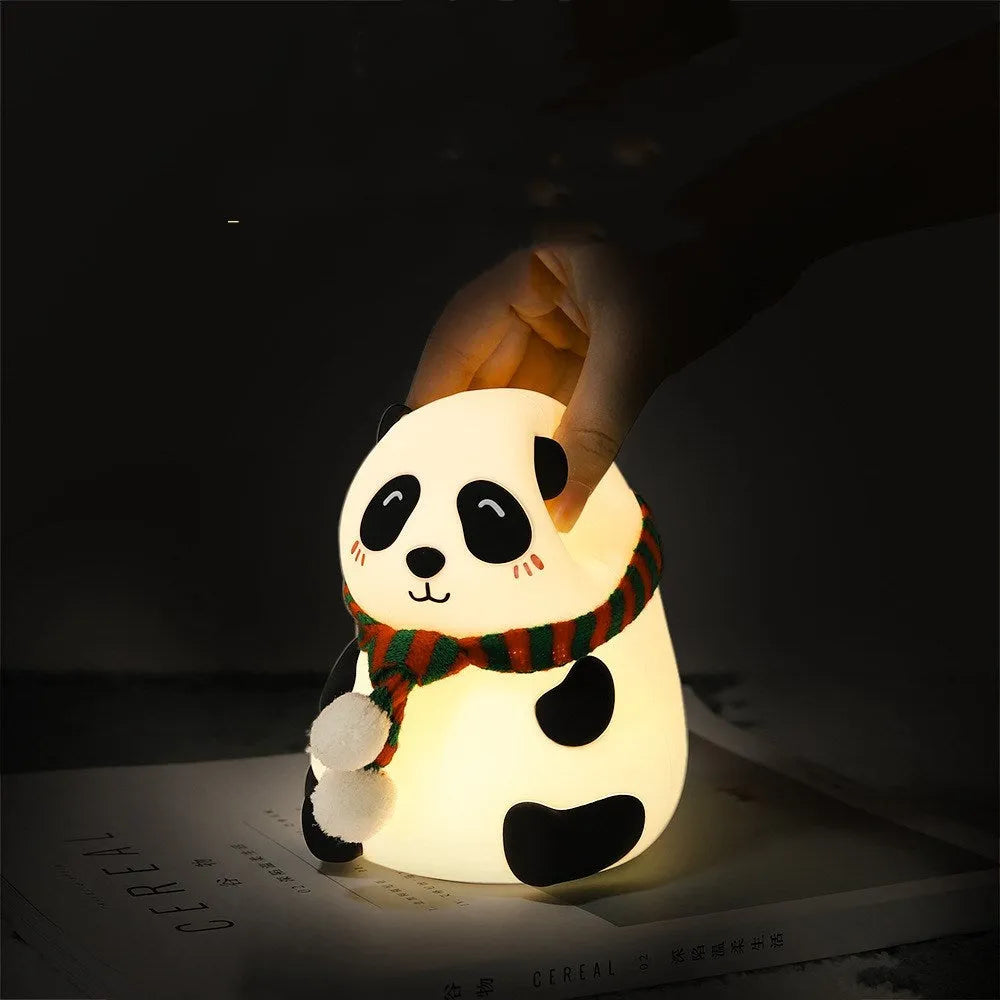 Panda-shaped silicone night light with USB cable on a wooden surface