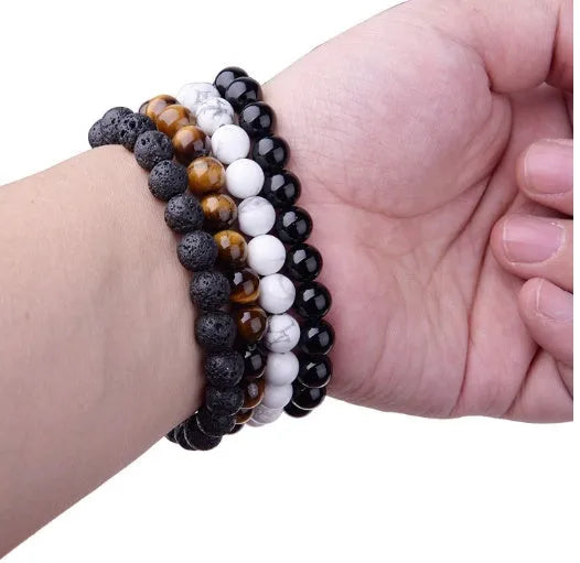 Women's geometric black agate bracelet with elastic cord, shown in 8mm bead size.