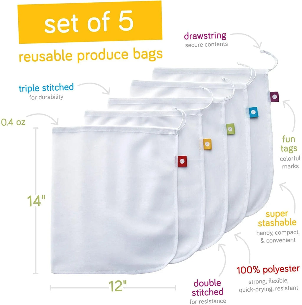 Five white cotton drawstring bags for kitchen vegetable storage arranged on a clean surface